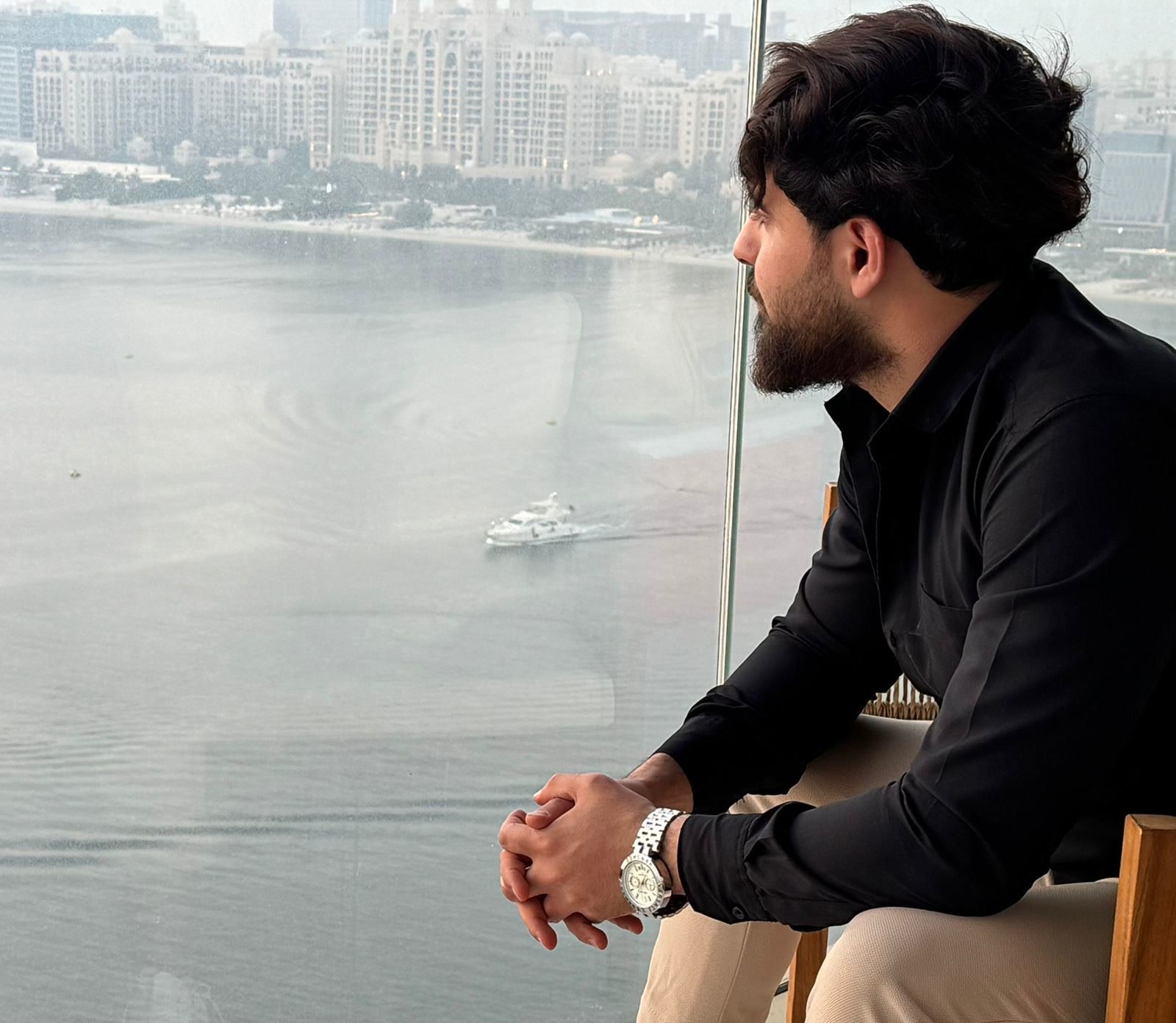Ahmed Gamal at a window overlooking the Palm Jumeirah